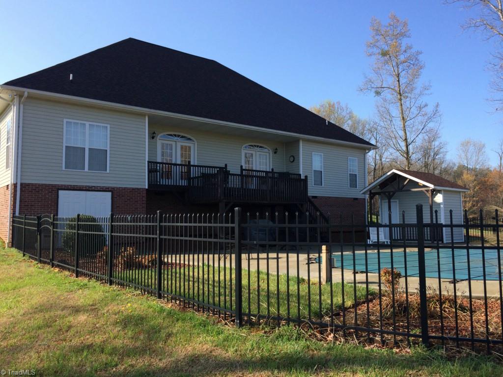175 Sourwood Road State Road, NC 28676 - Photo 17 of 24 Exit the rear main level from the great room to the multi-level decking that leads to the fenced outdoor patio and swimming pool.
