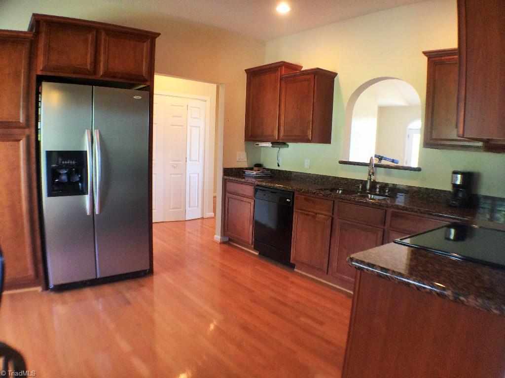 Enjoy modern amenities of the kitchen.  Floors of hardwood with Marsh Cabinets covered in Granite, Side-by-Side Refrigerator, Whirlpool self-cleaning smooth top electric range, whirlpool dishwasher, a micro-hood, breakfast area and a work-station.