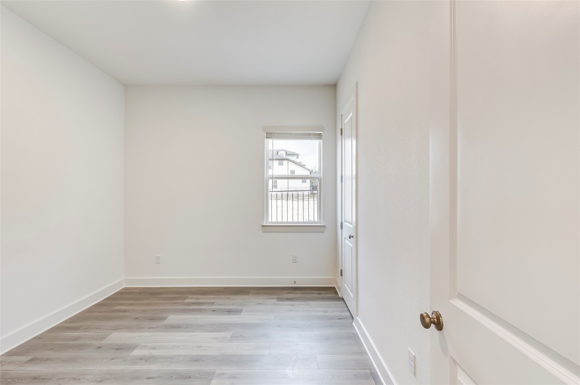 2000 Kit Circle Austin, TX 78758 - Photo 13 of 34 Spare room featuring light wood finished floors and baseboards