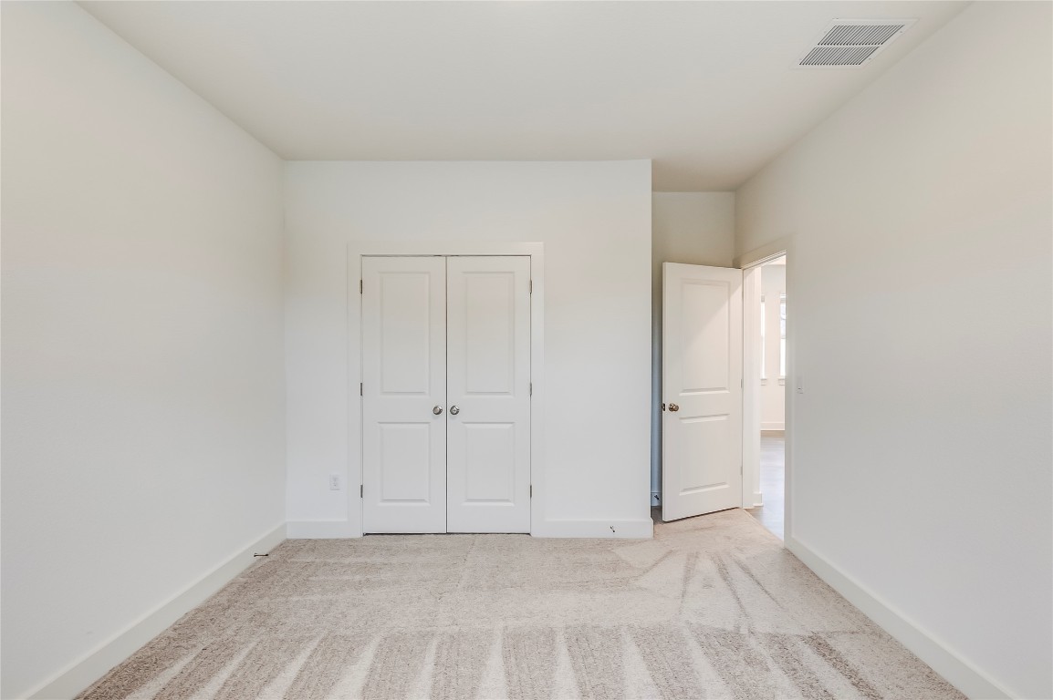 2000 Kit Circle Austin, TX 78758 - Photo 24 of 34 Unfurnished bedroom featuring light colored carpet and a closet