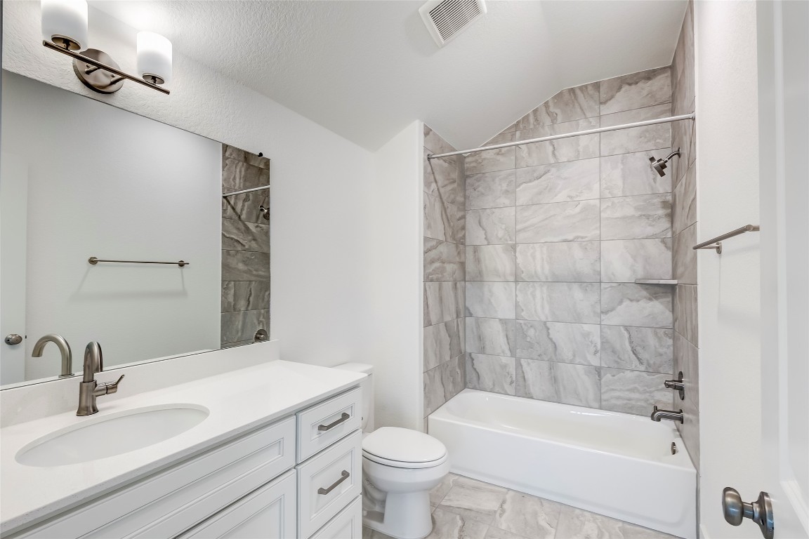 2000 Kit Circle Austin, TX 78758 - Photo 29 of 34 Full bath featuring shower / bath combination, vaulted ceiling, and vanity