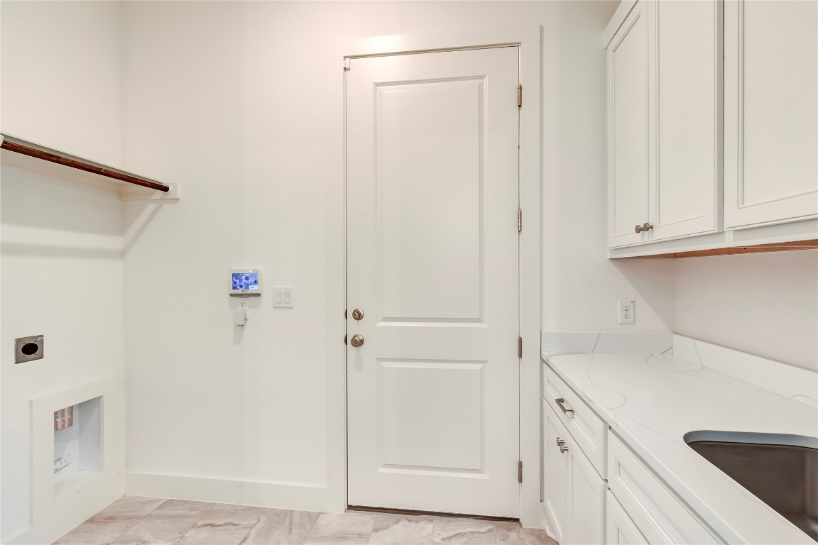 2000 Kit Circle Austin, TX 78758 - Photo 30 of 34 Laundry room with light marble finish floors and hookup for an electric dryer