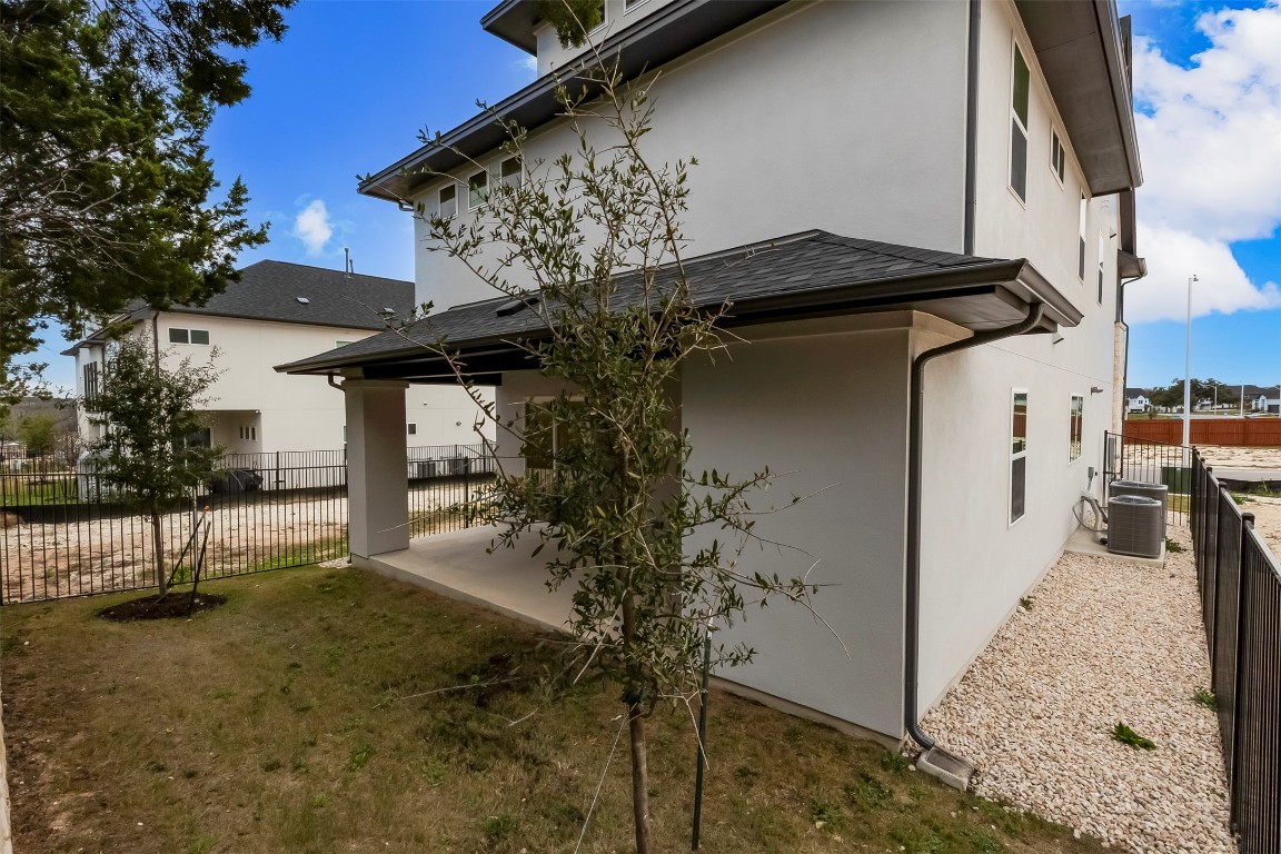 2000 Kit Circle Austin, TX 78758 - Photo 32 of 34 Rear view of house with a patio area and stucco siding