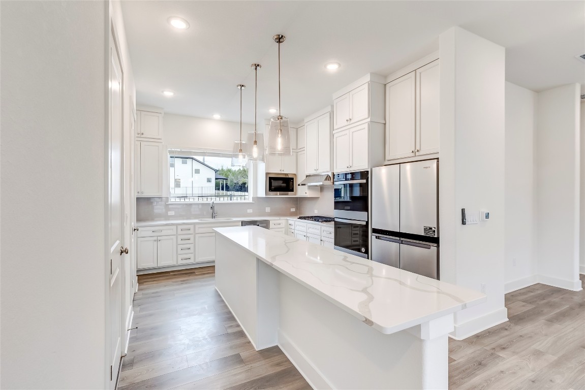 2000 Kit Circle Austin, TX 78758 - Photo 9 of 34 Kitchen with white cabinetry, stainless steel appliances, light wood-style flooring, and recessed lighting