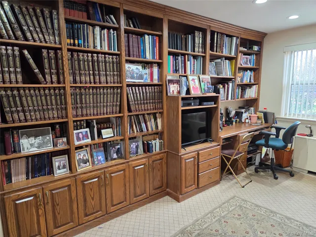 a view of a workspace with bookshelf