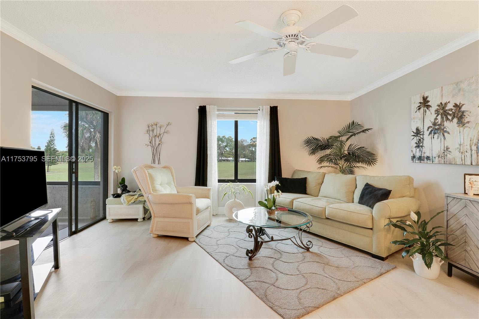 5313 Southeast Miles Grant Road, Unit 206 Stuart, FL 34997 - Photo 12 of 39 a living room with furniture and a flat screen tv