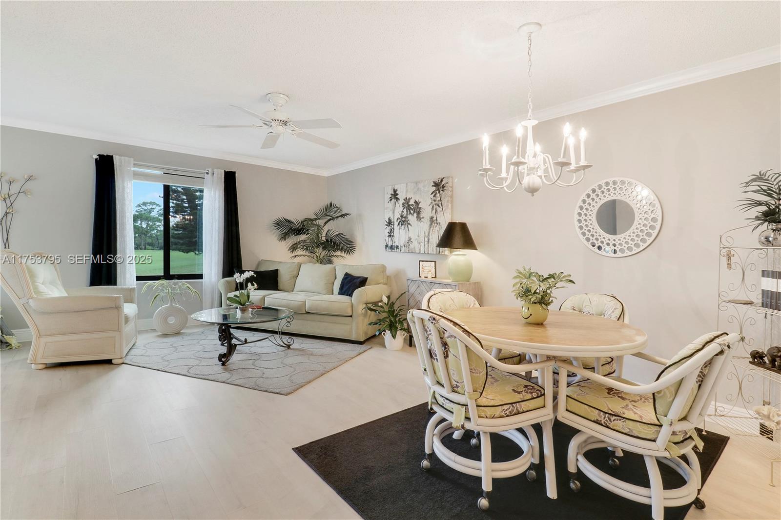 5313 Southeast Miles Grant Road, Unit 206 Stuart, FL 34997 - Photo 13 of 39 a living room with furniture and a chandelier