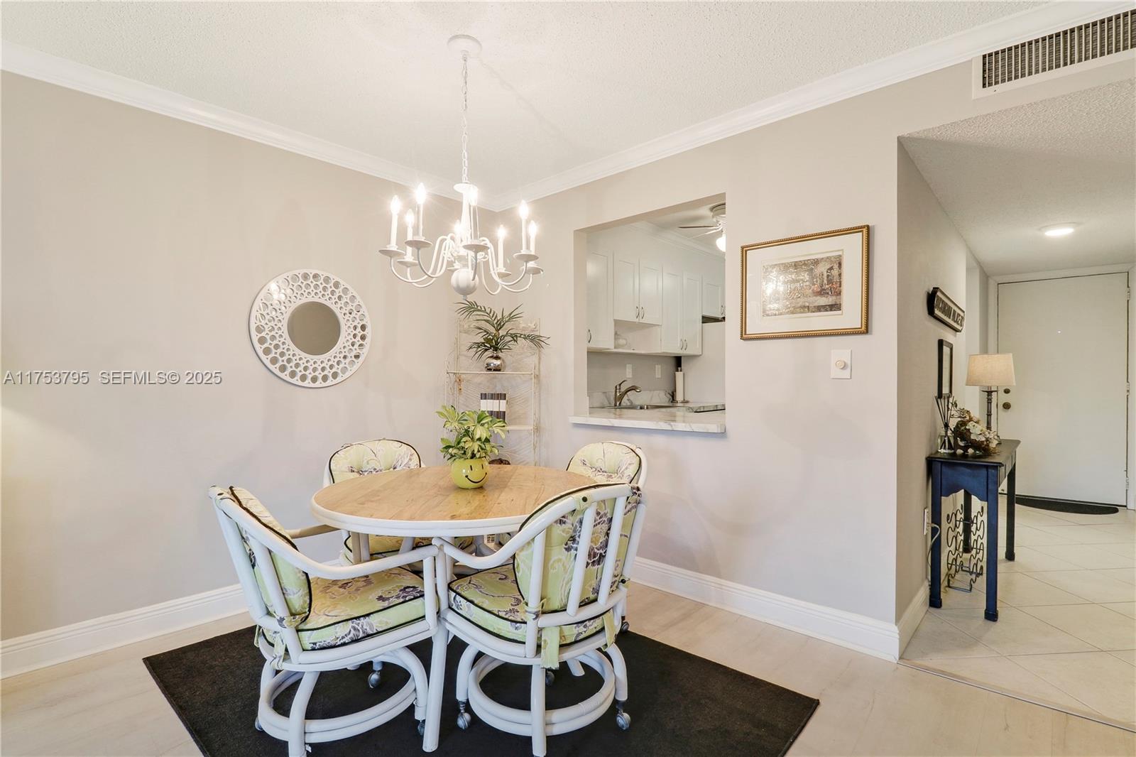 5313 Southeast Miles Grant Road, Unit 206 Stuart, FL 34997 - Photo 15 of 39 a dining room with furniture and chandelier