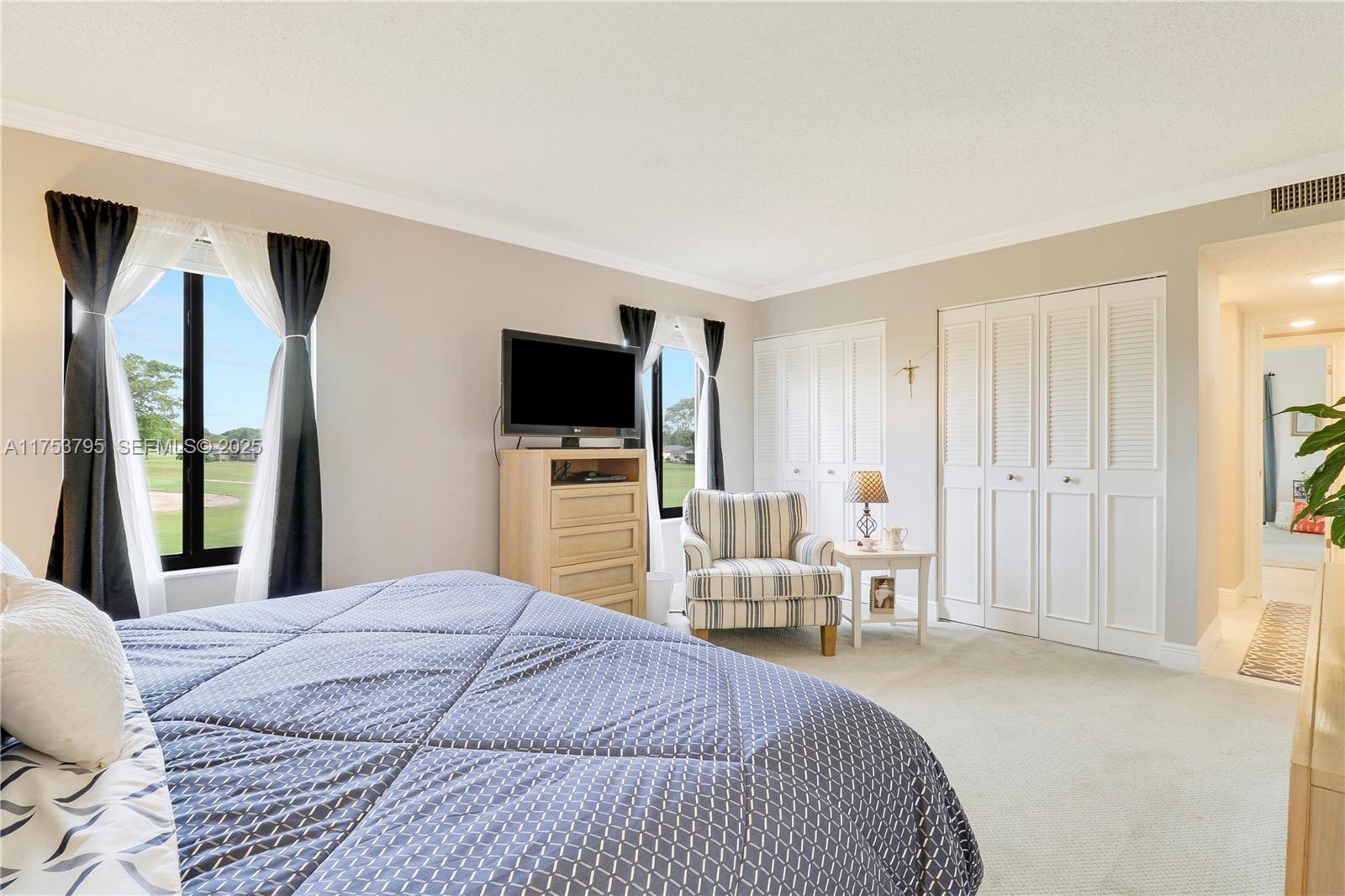 5313 Southeast Miles Grant Road, Unit 206 Stuart, FL 34997 - Photo 18 of 39 a bedroom with a bed and a flat screen tv