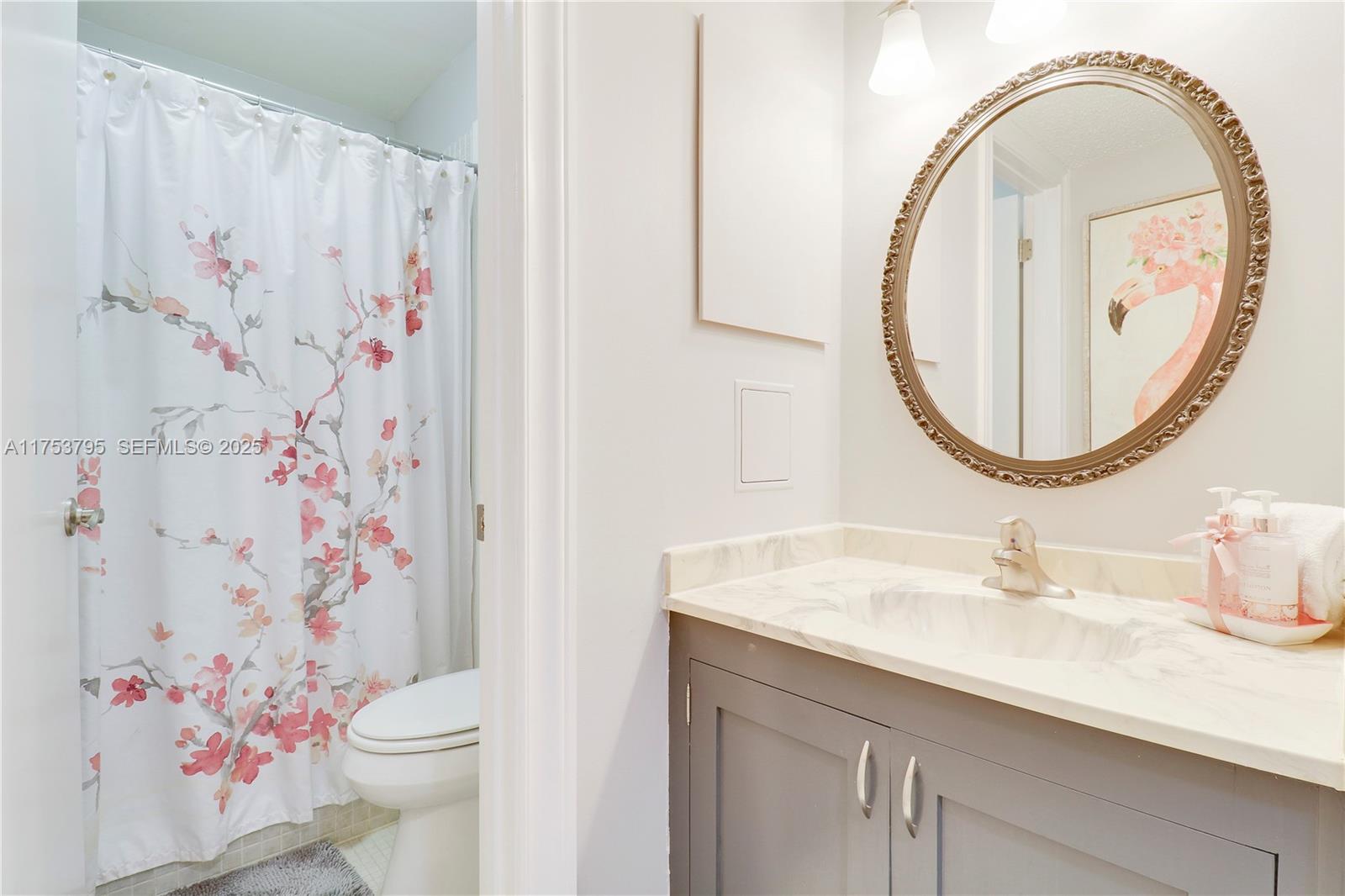 5313 Southeast Miles Grant Road, Unit 206 Stuart, FL 34997 - Photo 19 of 39 a bathroom with a sink toilet and a mirror