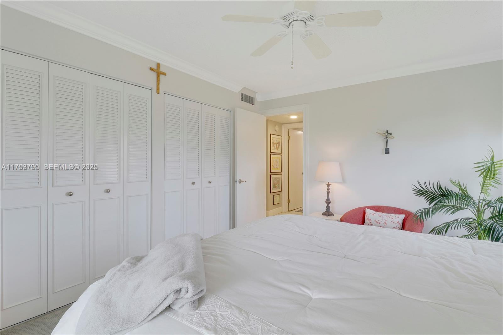 5313 Southeast Miles Grant Road, Unit 206 Stuart, FL 34997 - Photo 21 of 39 a bedroom with a bed and a chandelier