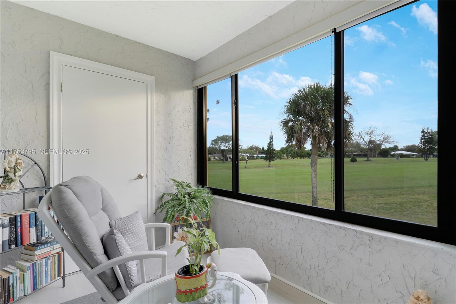 5313 Southeast Miles Grant Road, Unit 206 Stuart, FL 34997 - Photo 24 of 39 a living room with a floor to ceiling window and pool