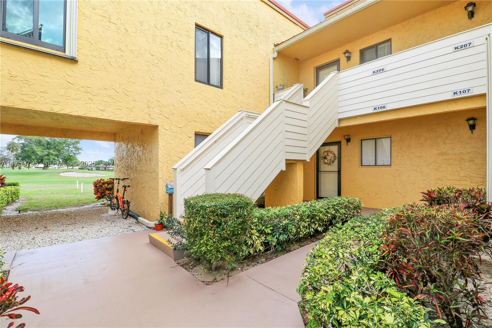 5313 Southeast Miles Grant Road, Unit 206 Stuart, FL 34997 - Photo 27 of 39 a front view of a house with a yard