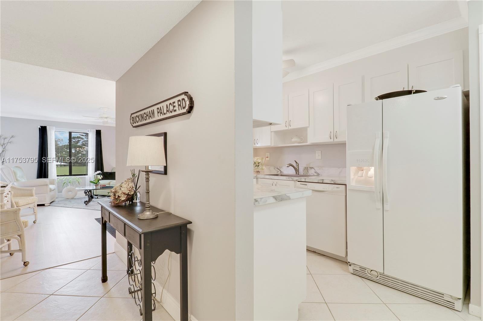 5313 Southeast Miles Grant Road, Unit 206 Stuart, FL 34997 - Photo 5 of 39 a kitchen with a refrigerator a sink and cabinets