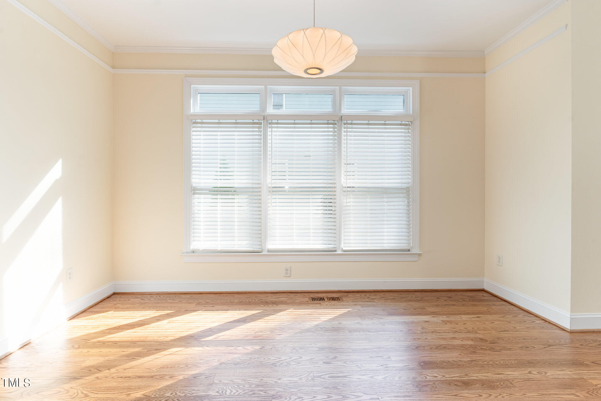 209 Stable Road Carrboro, NC 27510 - Photo 11 of 33 an empty room with wooden floor and windows