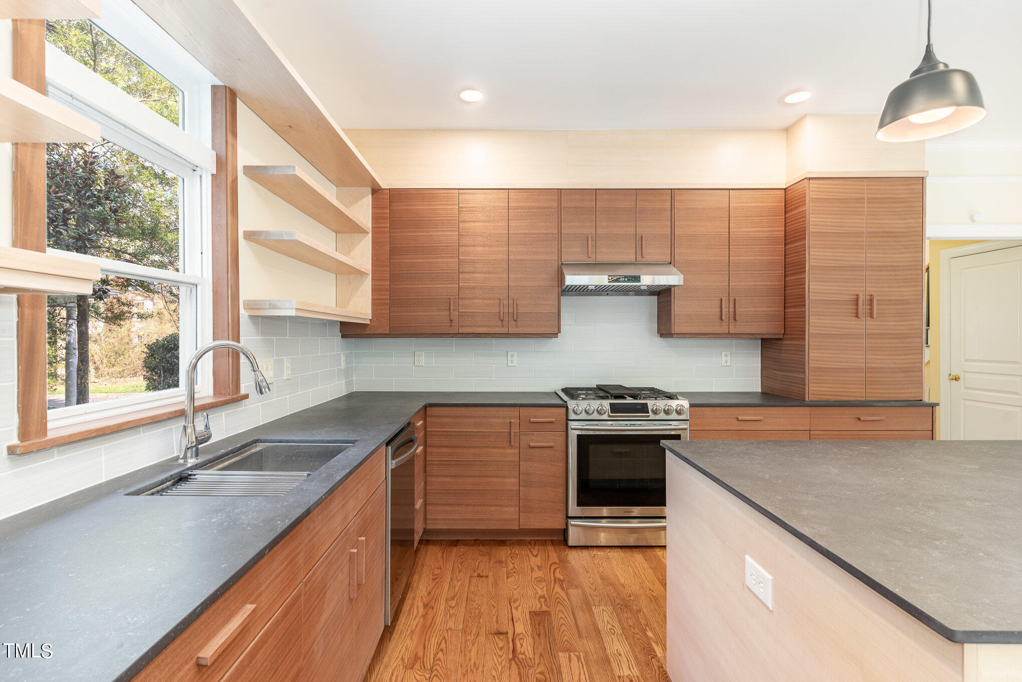 209 Stable Road Carrboro, NC 27510 - Photo 14 of 33 a kitchen with stainless steel appliances granite countertop a sink stove and cabinets