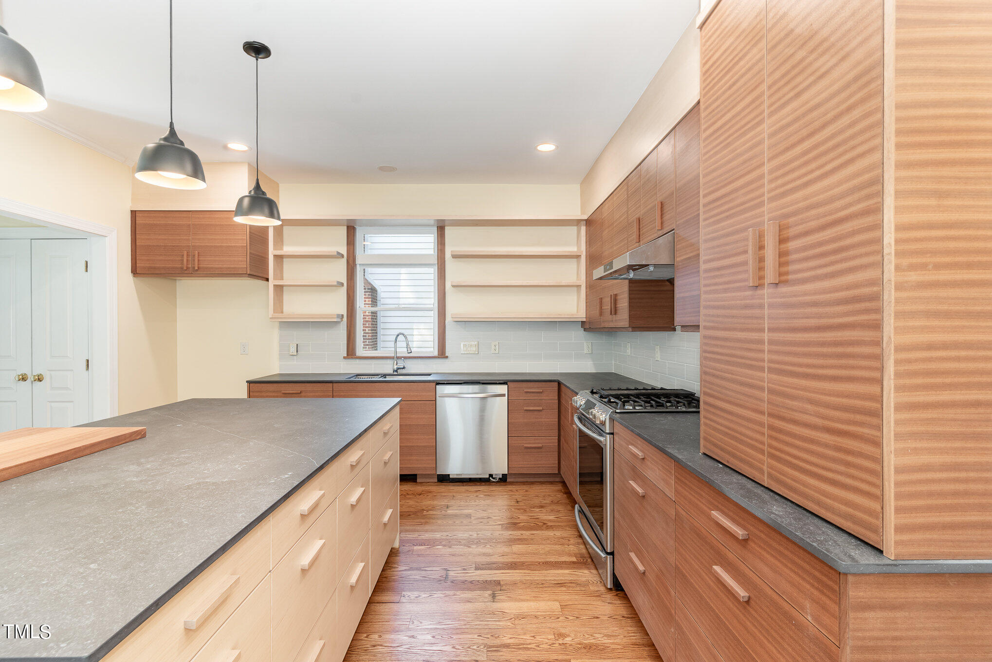 209 Stable Road Carrboro, NC 27510 - Photo 15 of 33 a kitchen with stainless steel appliances granite countertop a sink and stove