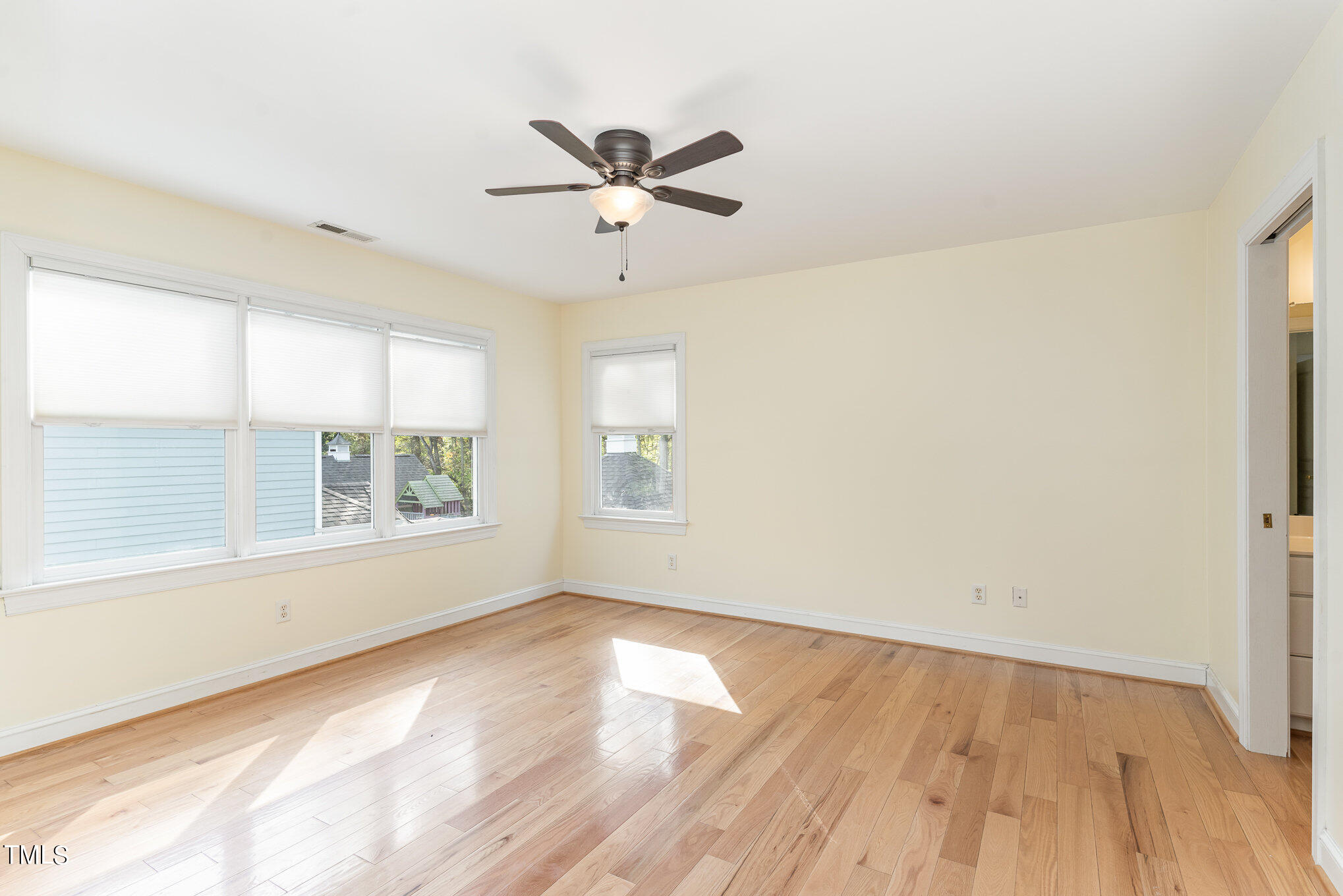209 Stable Road Carrboro, NC 27510 - Photo 18 of 33 an empty room with wooden floor fan and windows