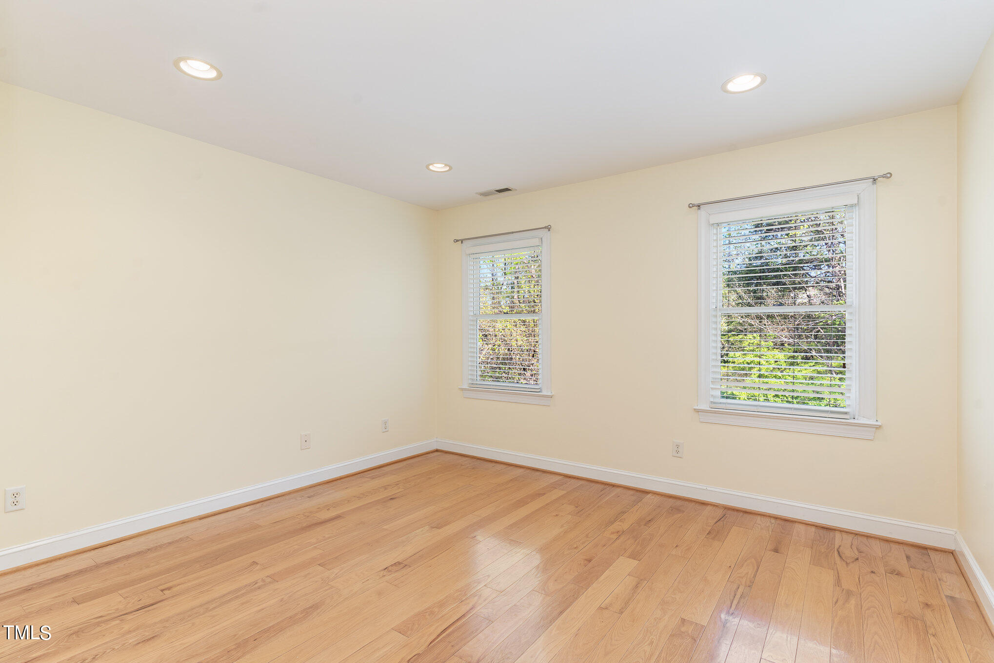 209 Stable Road Carrboro, NC 27510 - Photo 21 of 33 an empty room with wooden floor and windows