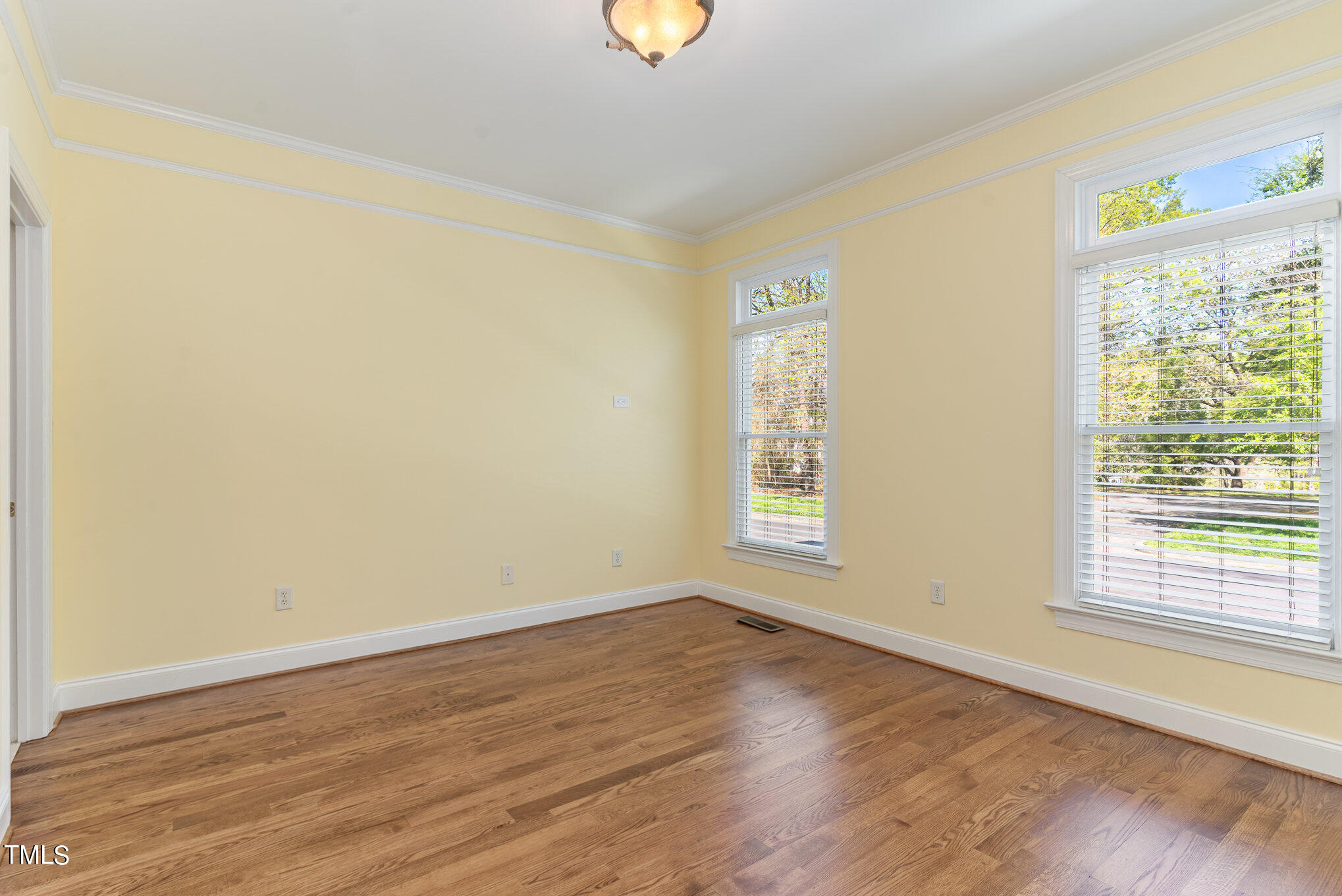 209 Stable Road Carrboro, NC 27510 - Photo 8 of 33 a view of an empty room with wooden floor and a window