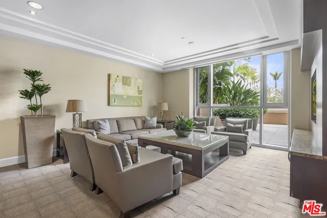 a living room with couches a coffee table and a large window with garden view