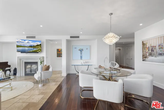a living room with fireplace furniture and a chandelier