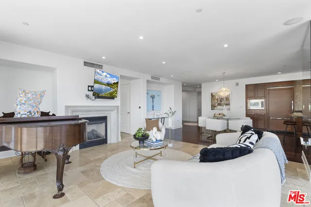 a living room with furniture a fireplace and a table