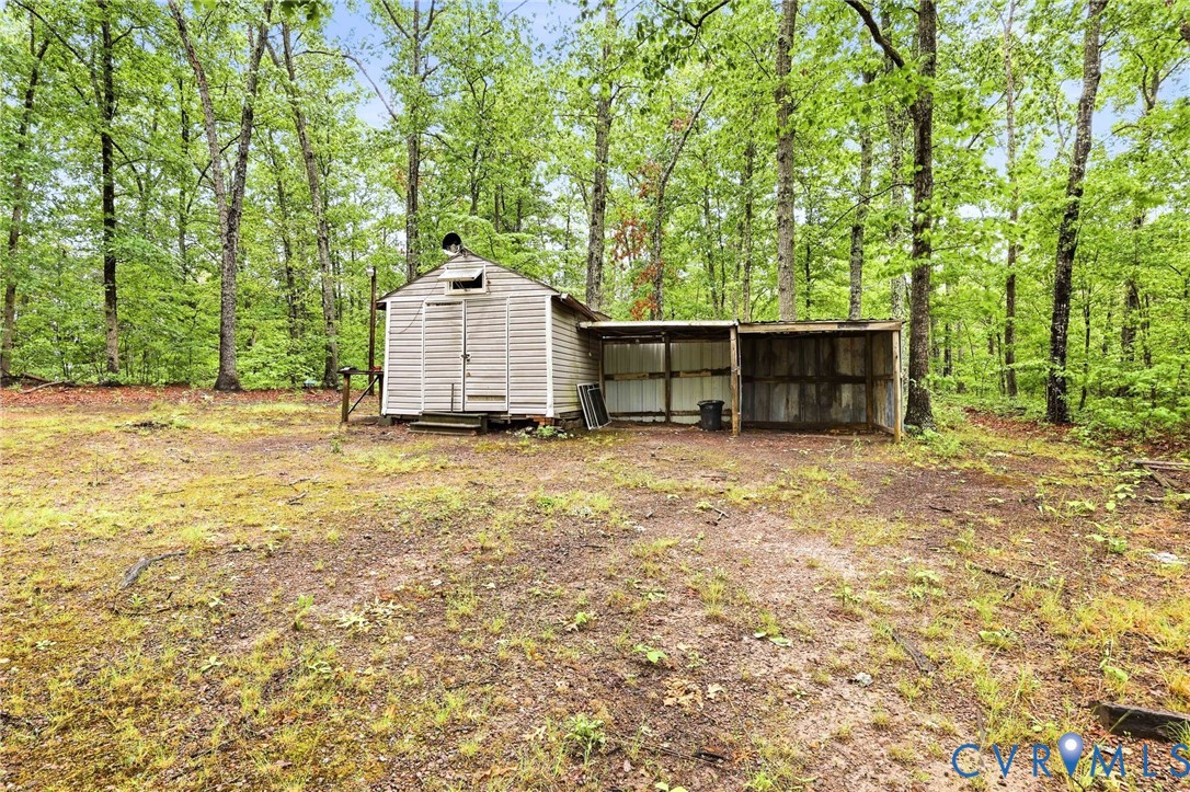 3220 Greenway Road Gladstone, VA 24553 - Photo 28 of 29 a backyard of a house with a large tree and wooden fence