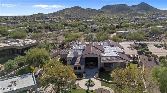 a living room with furniture a fireplace and a large window
