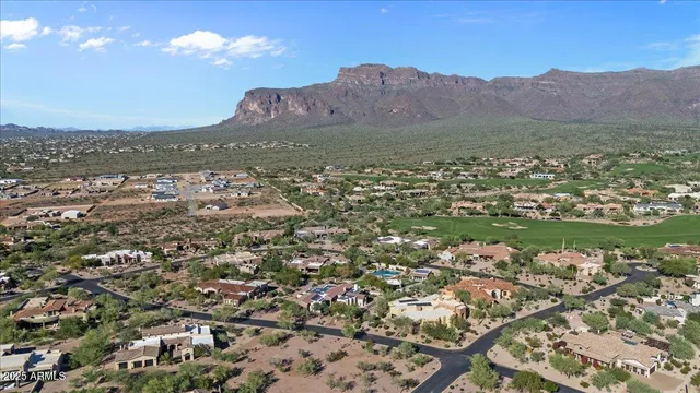 a spacious bedroom with a bed furniture and a flat screen tv