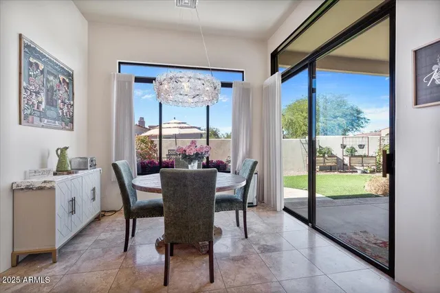 front view of a house with a yard table and chairs