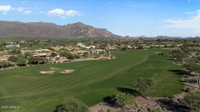 an aerial view of a house with a yard