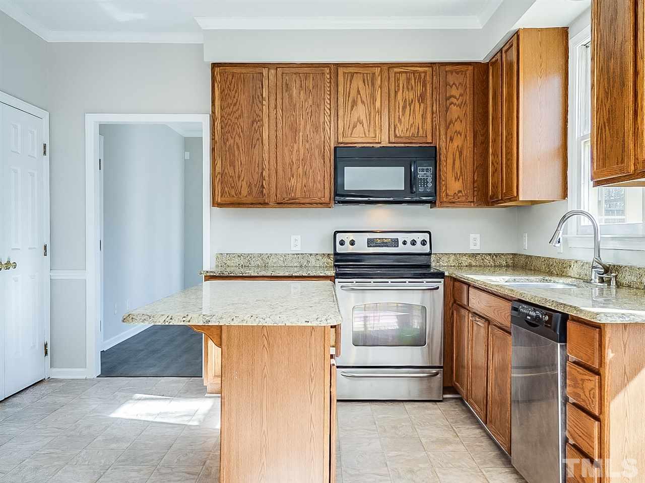 2500 Holbrook Court Raleigh, NC 27604 - Photo 2 of 26 a kitchen with a sink and a stove top oven