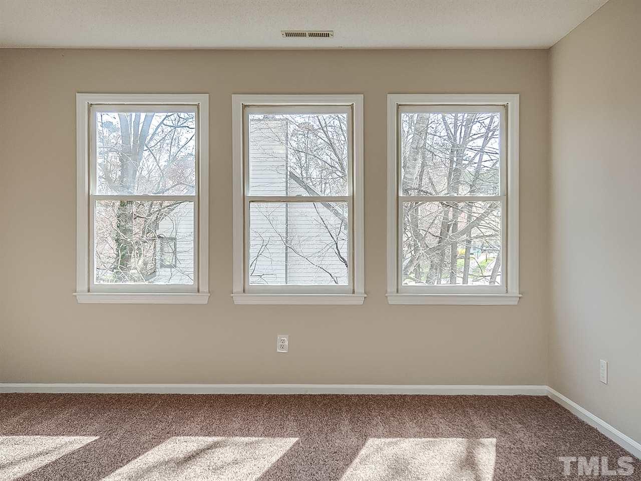2500 Holbrook Court Raleigh, NC 27604 - Photo 12 of 26 a view of an empty room with wooden floor and windows