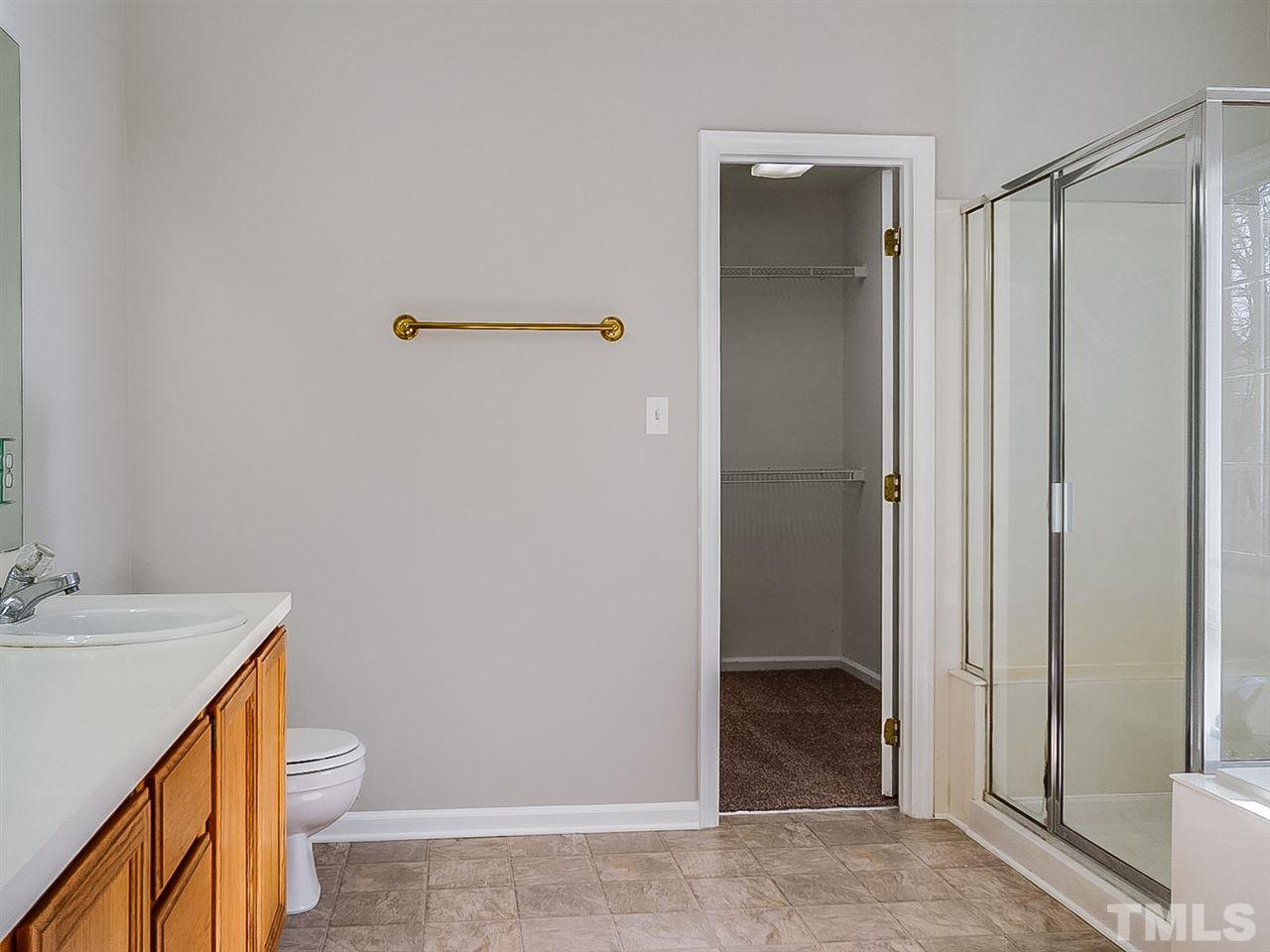 2500 Holbrook Court Raleigh, NC 27604 - Photo 14 of 26 a bathroom with a granite countertop sink toilet and shower