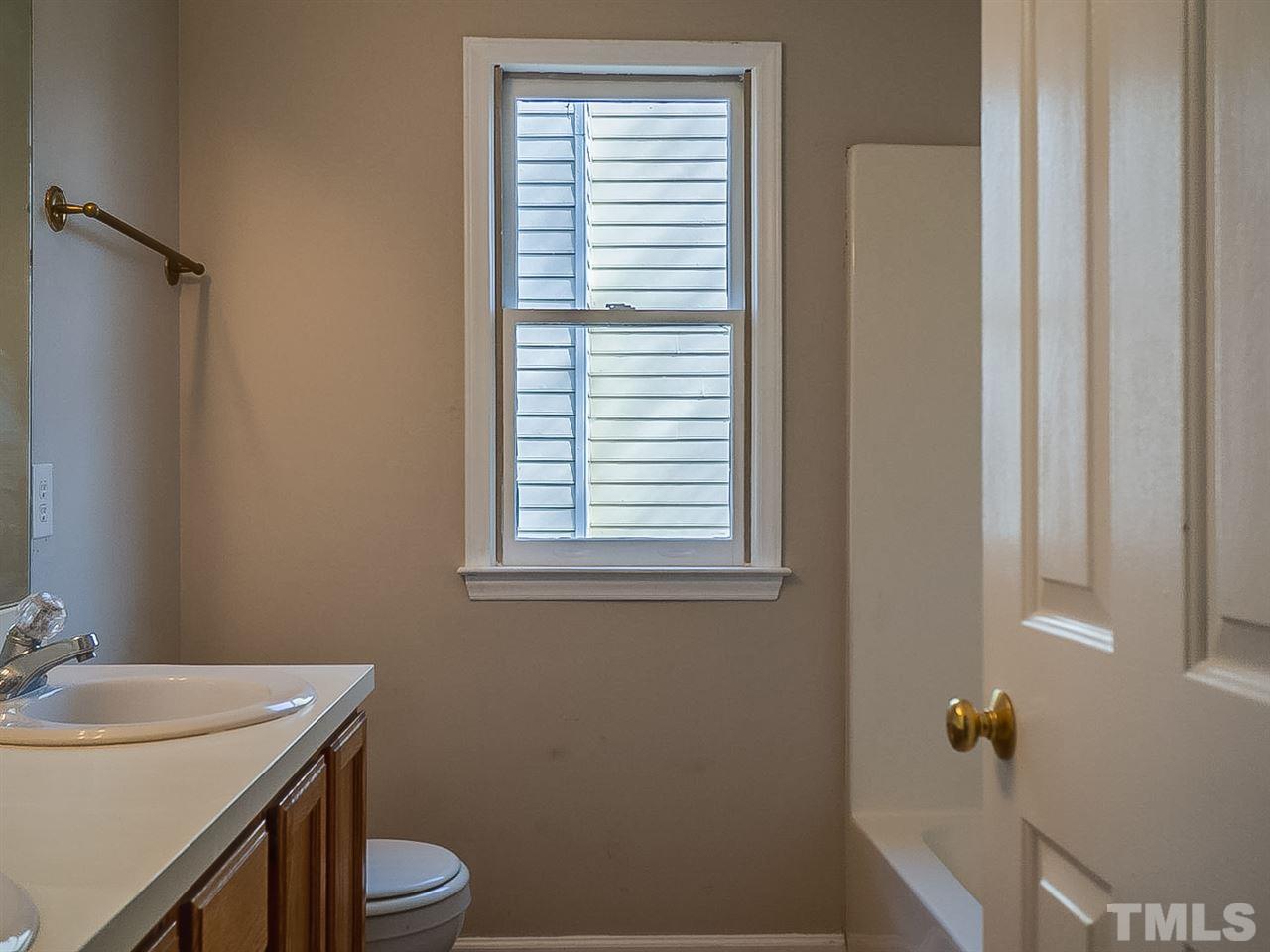 2500 Holbrook Court Raleigh, NC 27604 - Photo 23 of 26 a bathroom with a sink a toilet and shower