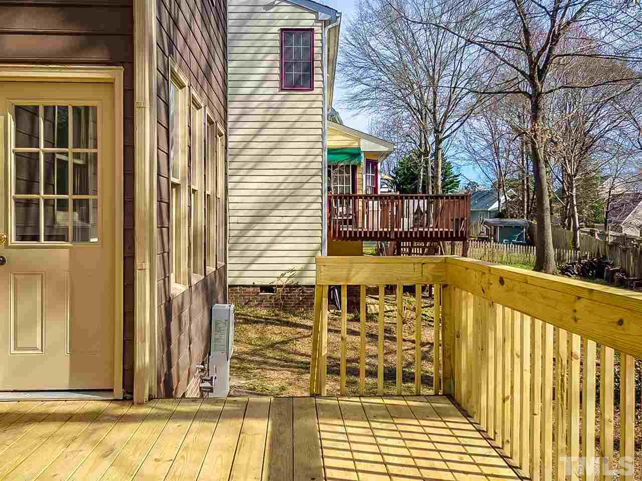 2500 Holbrook Court Raleigh, NC 27604 - Photo 25 of 26 a view of a balcony with wooden floor and fence and floor to ceiling window