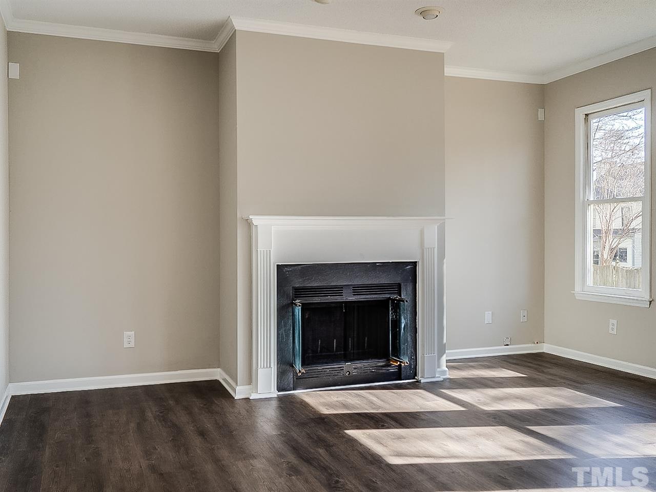 2500 Holbrook Court Raleigh, NC 27604 - Photo 6 of 26 a view of an empty room with a fireplace and a window