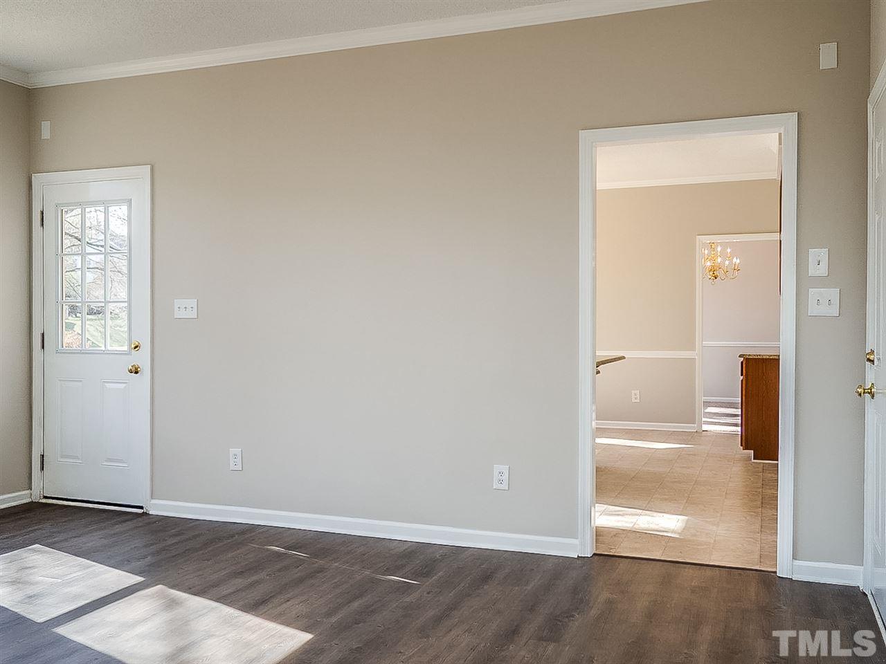 2500 Holbrook Court Raleigh, NC 27604 - Photo 8 of 26 an empty room with wooden floor cabinet and windows