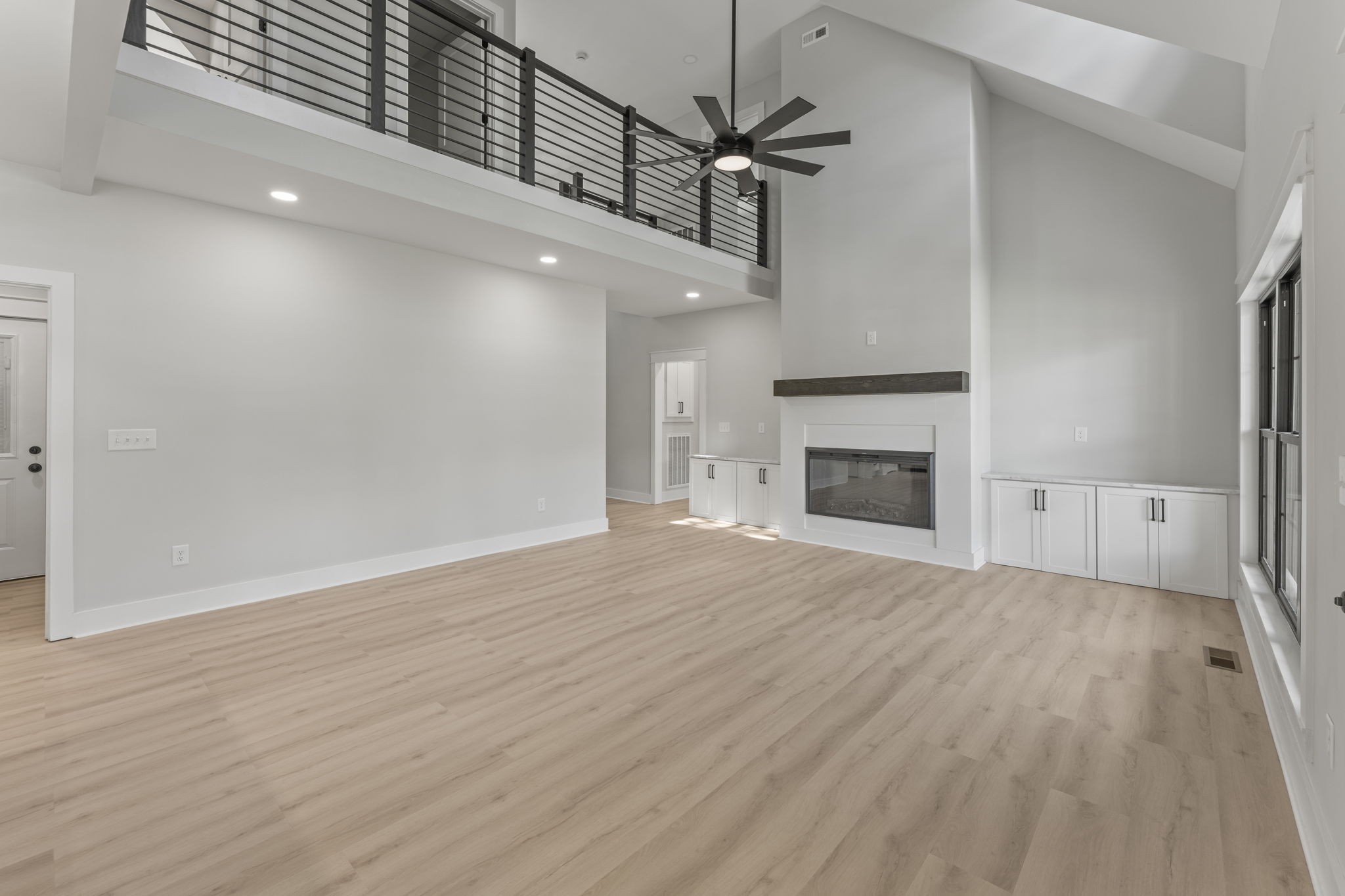 106 5th Avenue North Decherd, TN 37324 - Photo 11 of 50 an empty room with wooden floor fireplace and windows