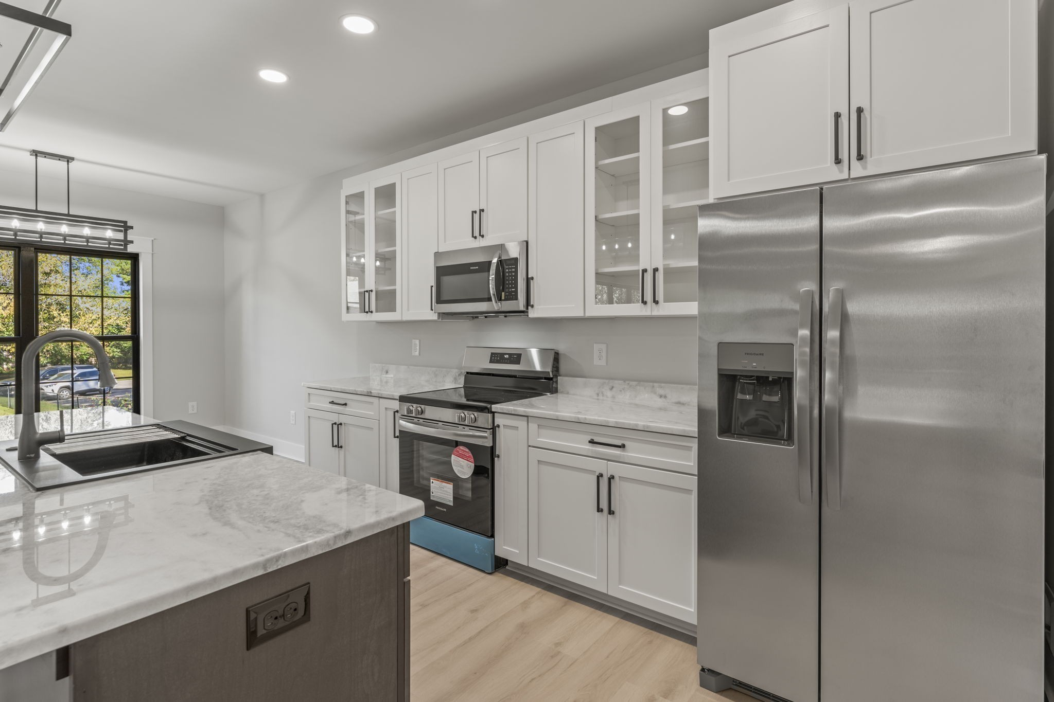 106 5th Avenue North Decherd, TN 37324 - Photo 14 of 50 a kitchen with kitchen island granite countertop stainless steel appliances and refrigerator