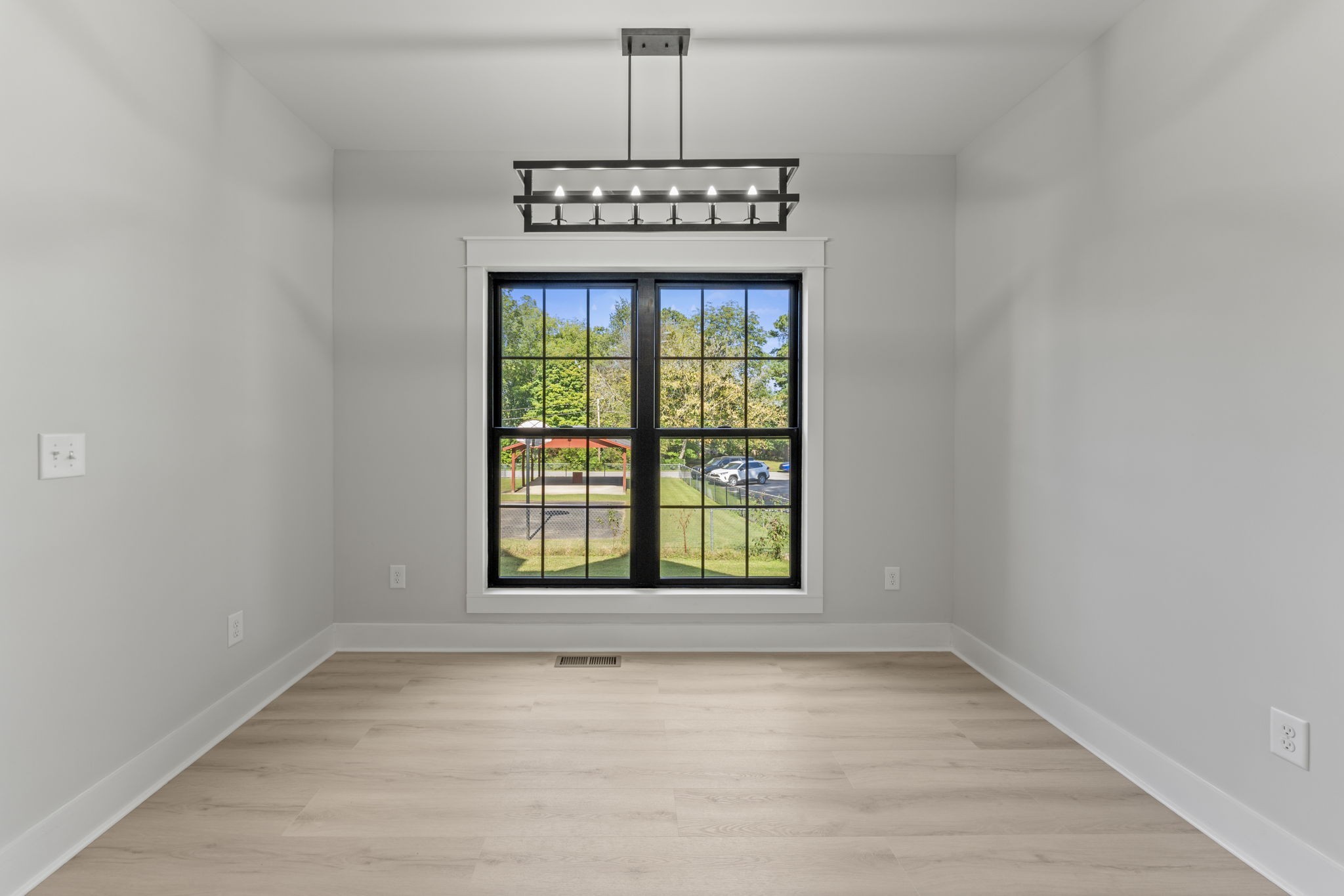 106 5th Avenue North Decherd, TN 37324 - Photo 16 of 50 a view of an empty room with a window and wooden floor