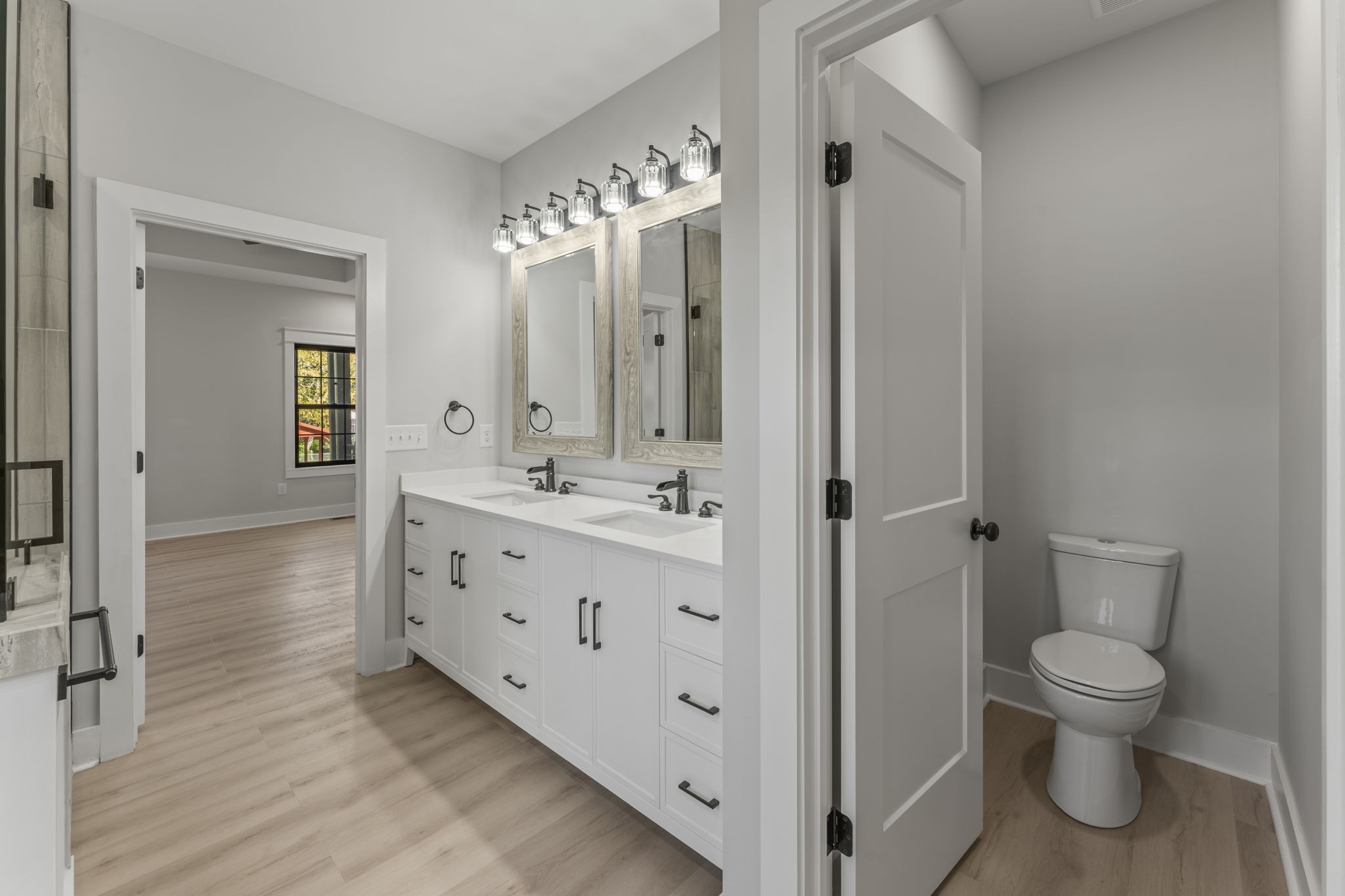 106 5th Avenue North Decherd, TN 37324 - Photo 21 of 50 a spacious bathroom with a double vanity sink a toilet and a large mirror