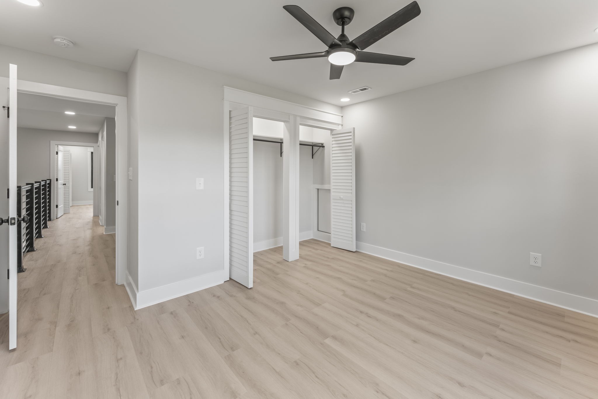 106 5th Avenue North Decherd, TN 37324 - Photo 31 of 50 an empty room with wooden floor and a ceiling fan