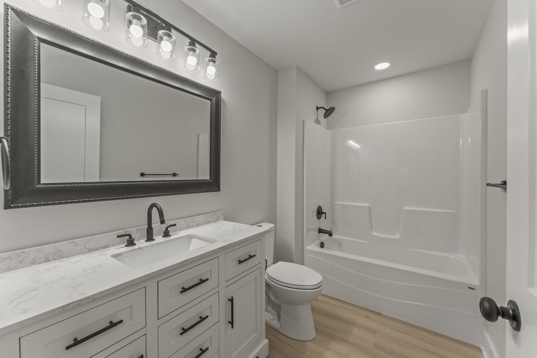 106 5th Avenue North Decherd, TN 37324 - Photo 32 of 50 a bathroom with a toilet a sink a mirror a bathtub and vanity