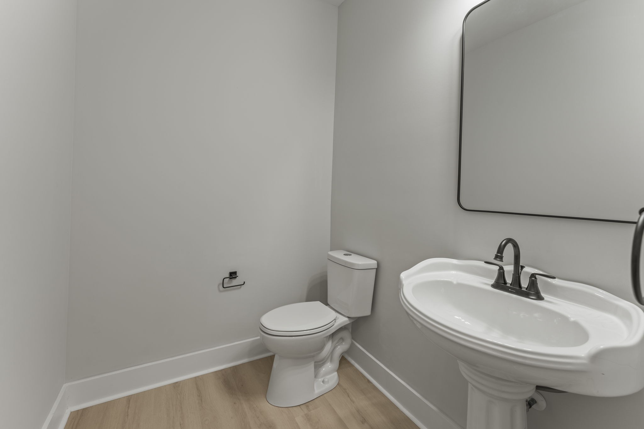 106 5th Avenue North Decherd, TN 37324 - Photo 38 of 50 a white toilet sitting next to a bathroom sink