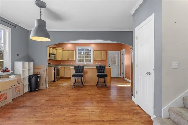 a view of a a dining room with furniture window and wooden floor