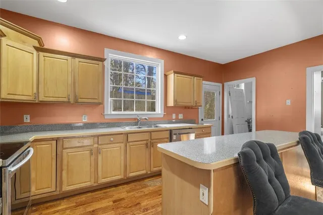 a kitchen with a stove a sink and a refrigerator