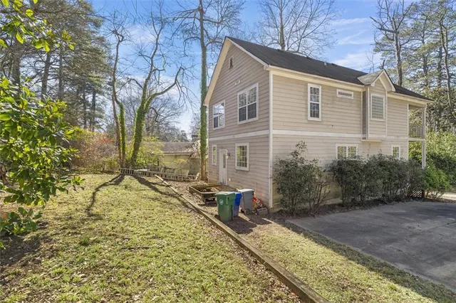 a backyard of a house with large trees and barbeque oven