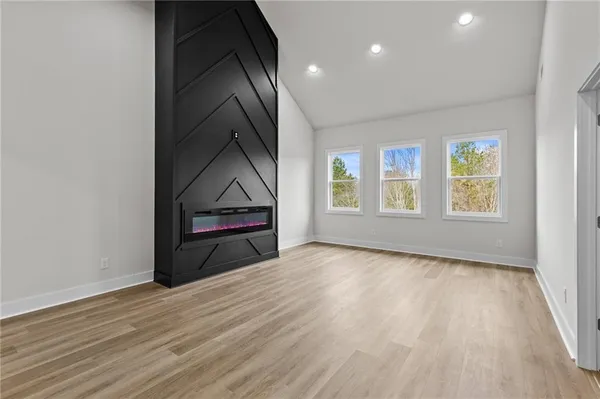 a view of an empty room and wooden floor